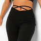 Black flared trousers with V-shaped lacing
