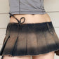 Irregularly pleated mini denim skirt