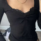 Black long-sleeved knit top with lace trim